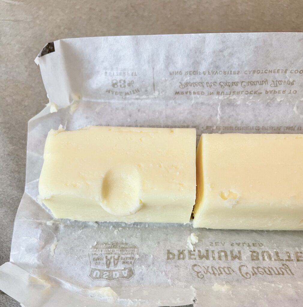 stick of butter with fingerprint pushed in