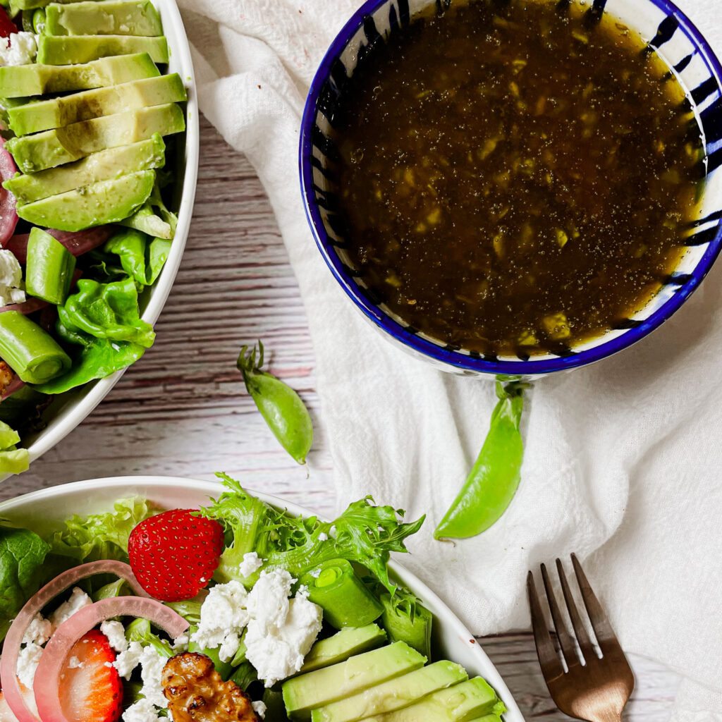 basil balsamic vinaigrette in a blue and white ceramic bowl