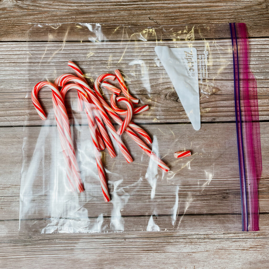 Candy canes in a ziplock bag on wooden countertop.