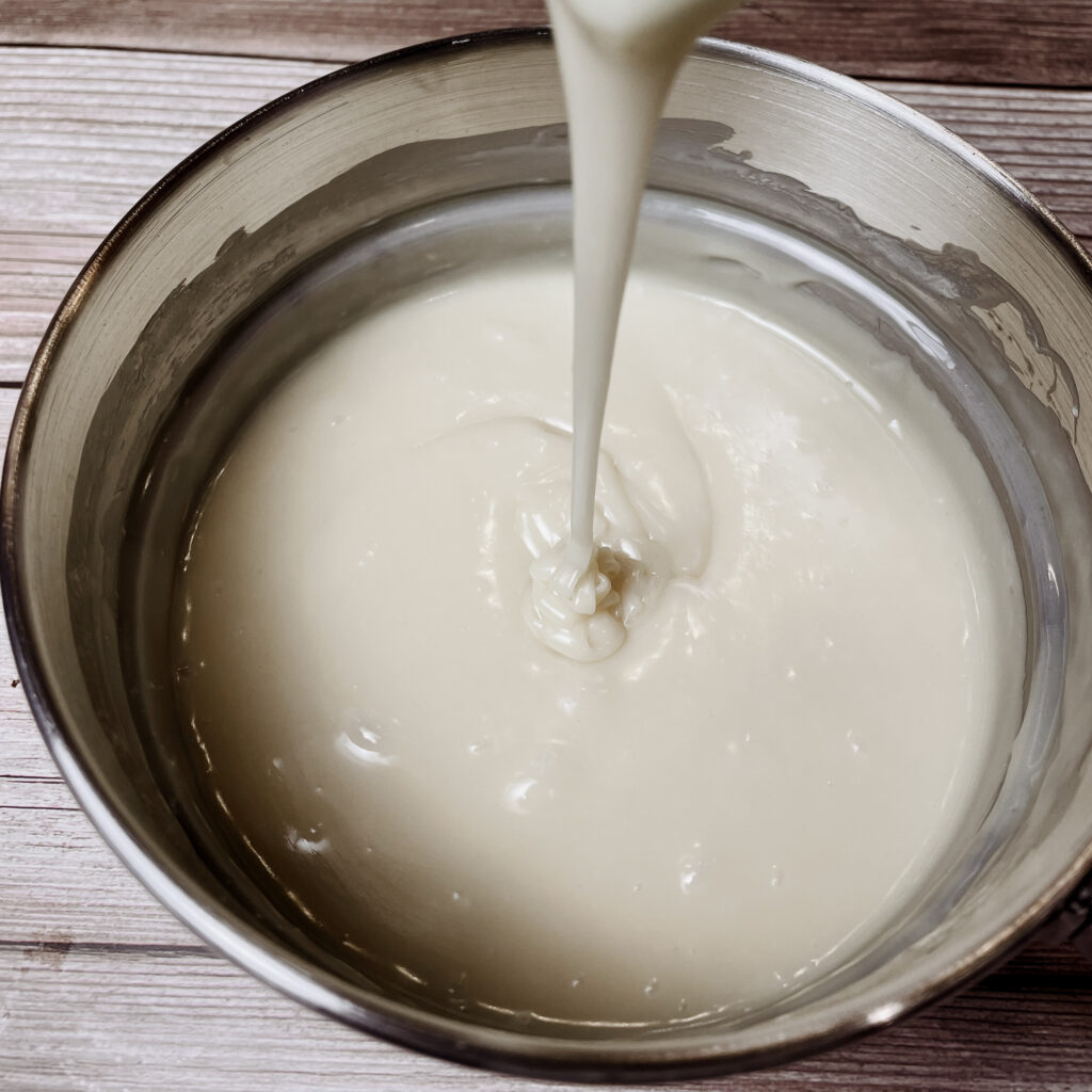 Melted white chocolate, heavy cream and peppermint extract in the top half of a double boiler.