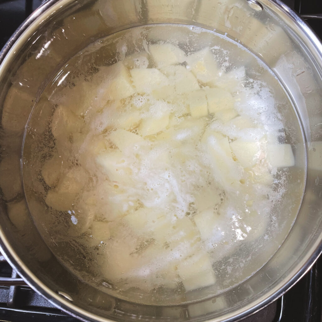 cubed potatoes in a pot of boiling water