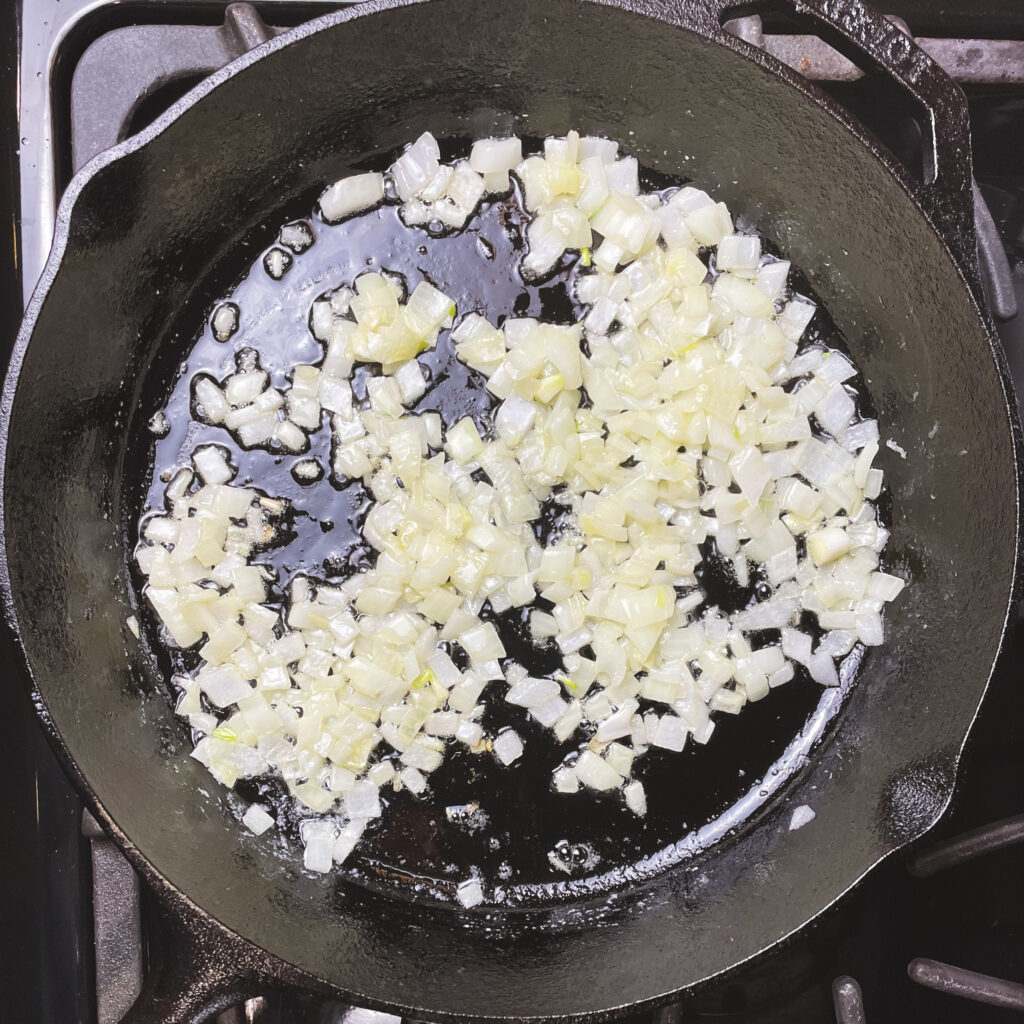 sautéed onions and garlic in a cast iron pan