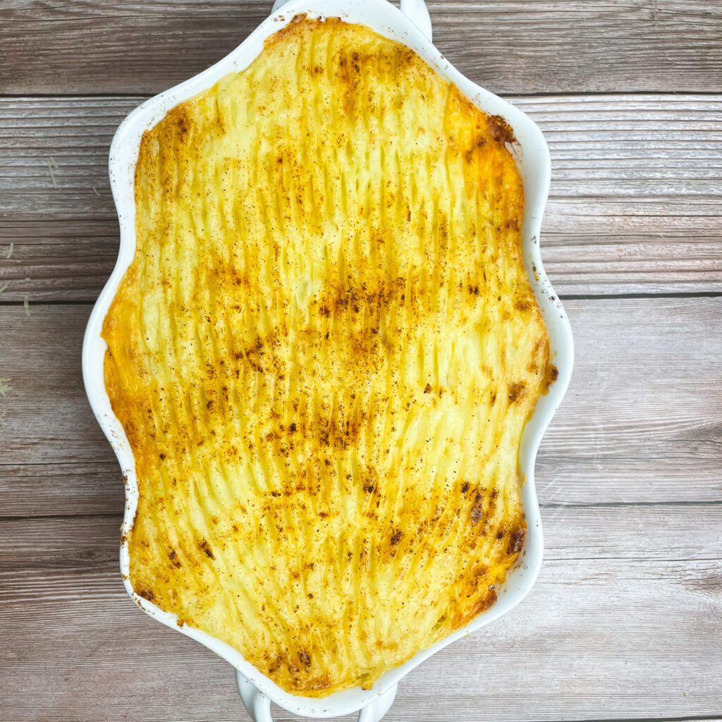 baked shepherd's pie in a white casserole dish
