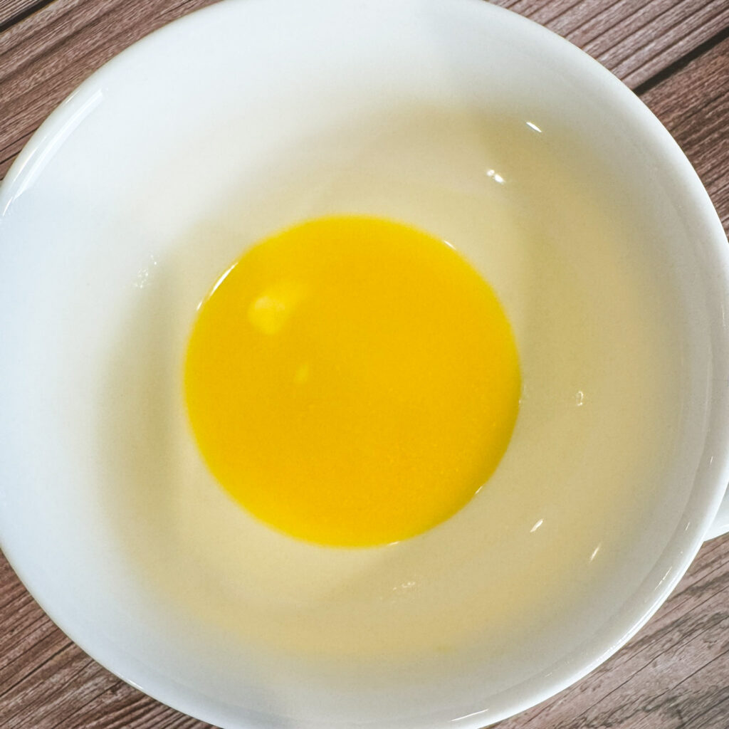 Melted butter in a white bowl, ready to mix with panko breadcrumbs and Parmesan for a golden, crunchy mac and cheese topping.