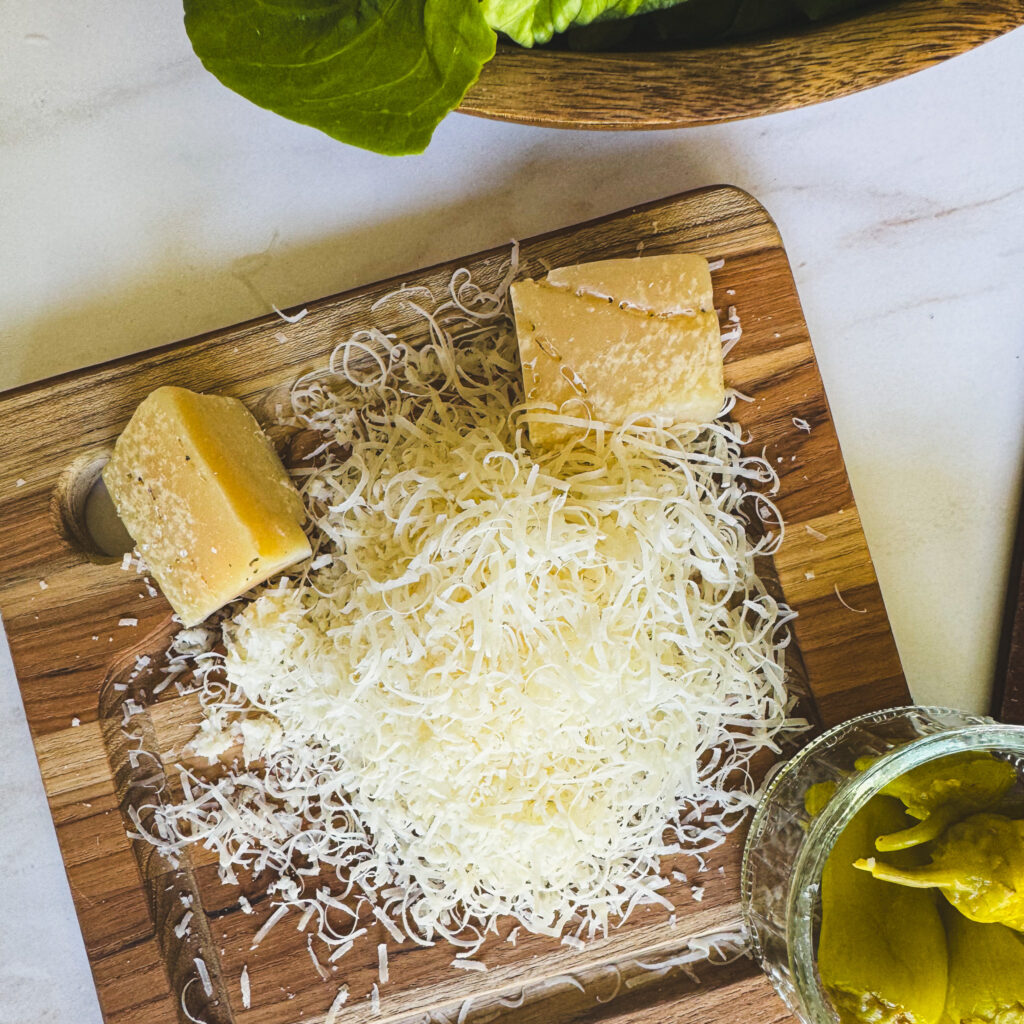 Freshly grated Parmesan cheese for topping an Italian salad with creamy Italian dressing.