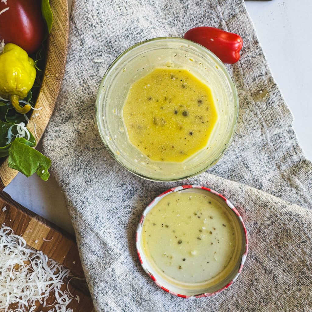 Creamy homemade Italian dressing mixed in a mason jar with herbs and seasonings.