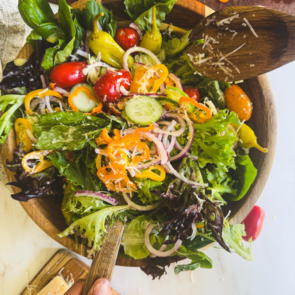 Fresh Italian house salad tossed with creamy Italian dressing and topped with grated Parmesan cheese.