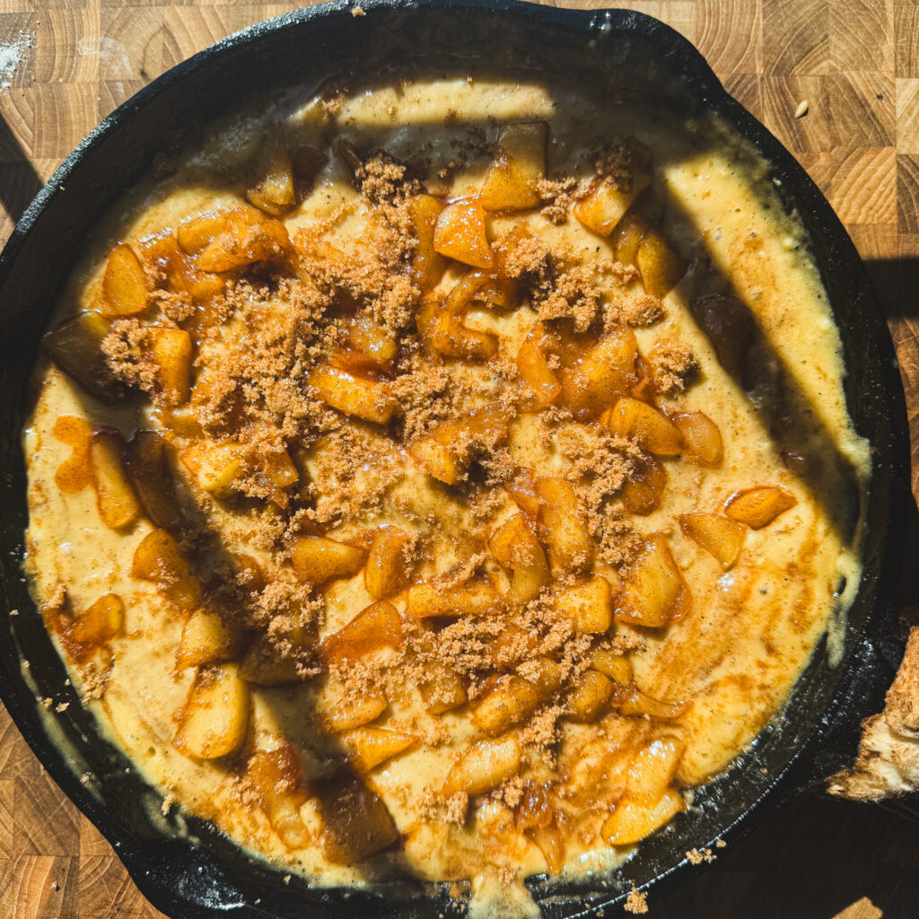 Final apple layer: Cinnamon apples and brown sugar layered on top of apple fritter cake batter before baking.