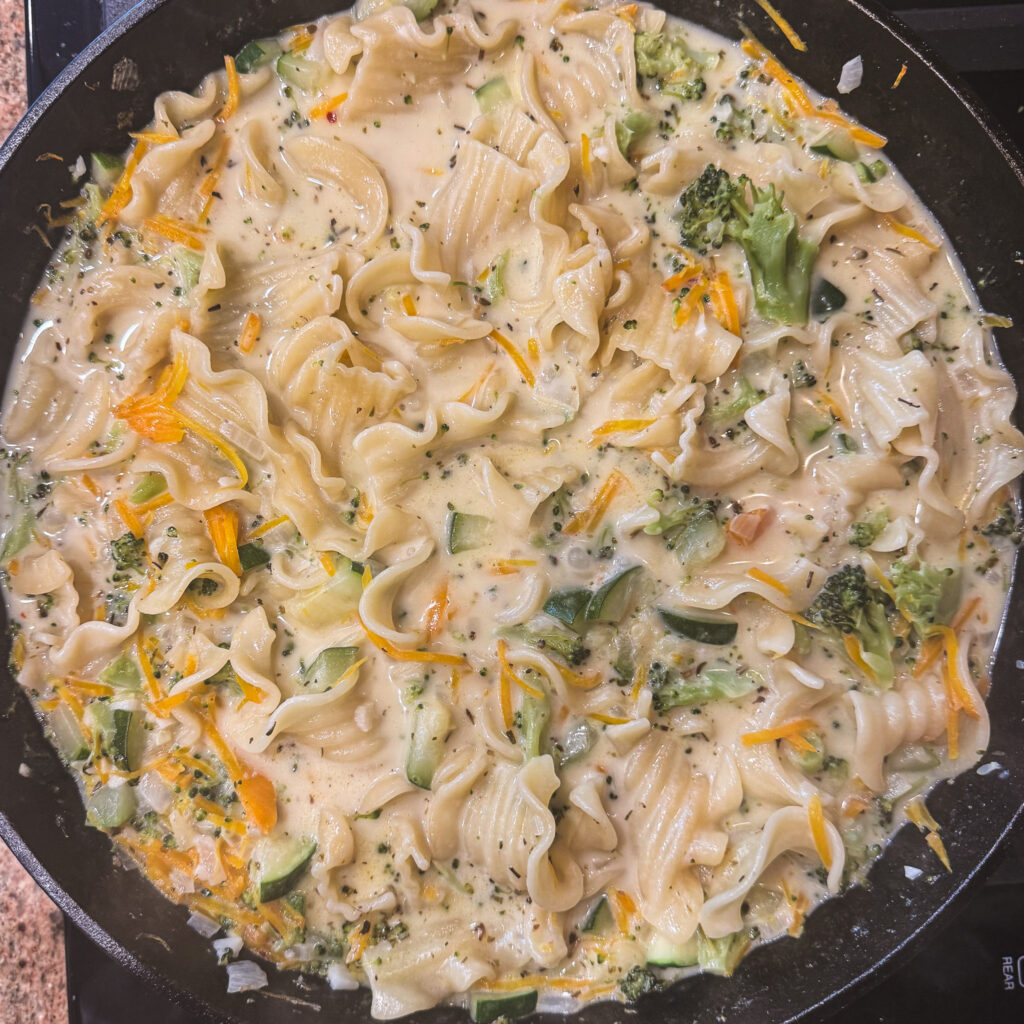 Creamy skillet white lasagna primavera with tender noodles, broccoli, zucchini and carrots.