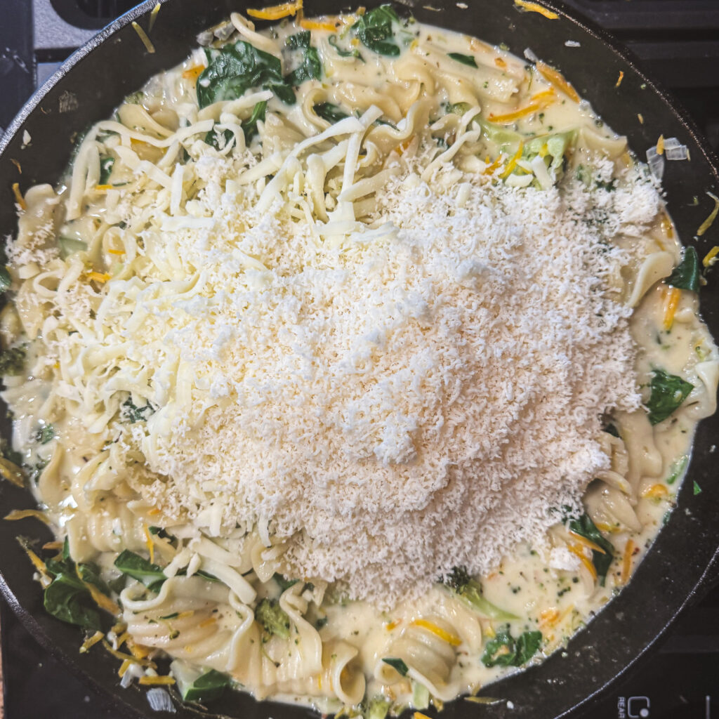 Mozzarella and Parmesan cheese added to creamy skillet lasagna primavera.