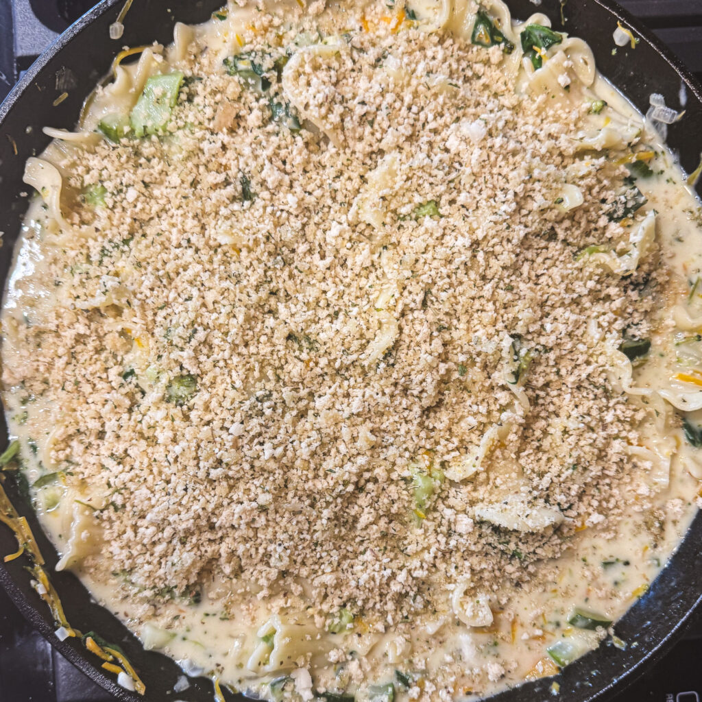 Creamy vegetable lasagna topped with seasoned panko breadcrumbs before broiling.