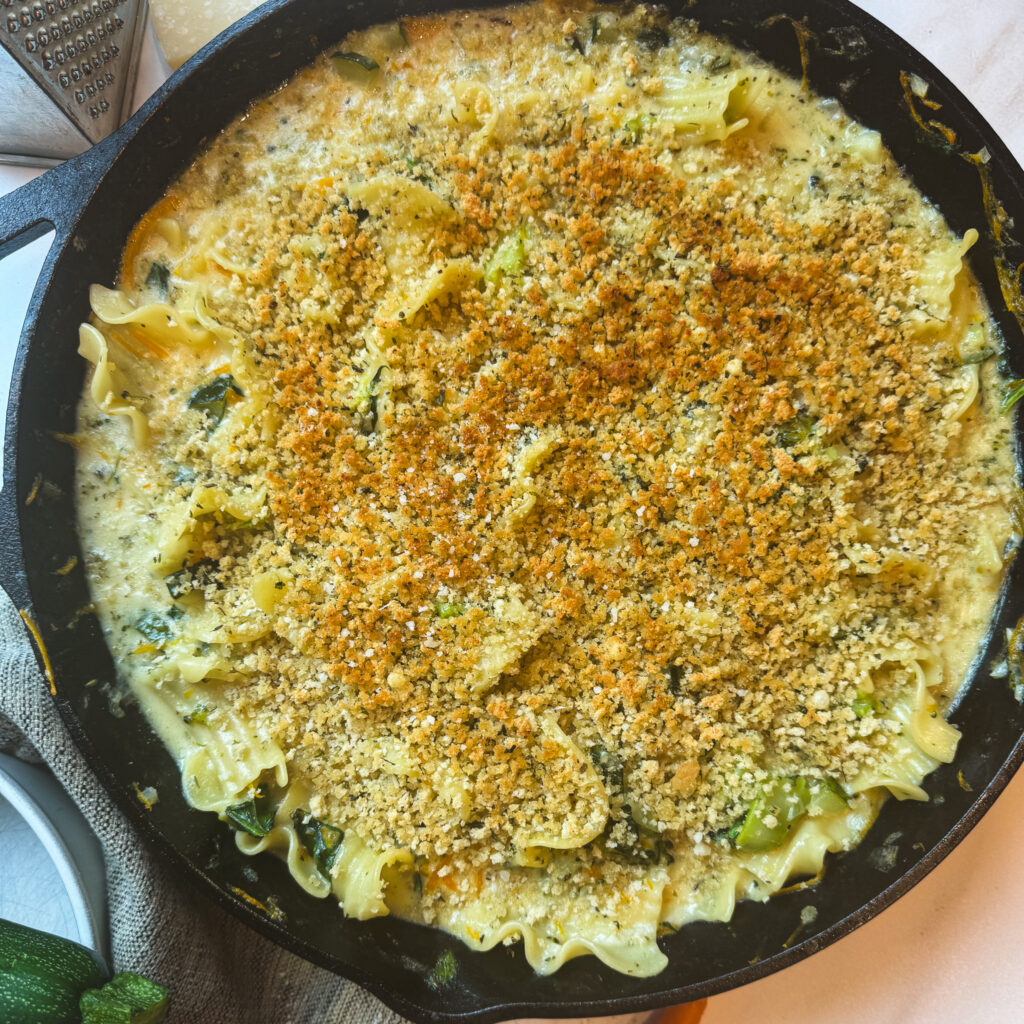 Skillet white lasagna primavera with a golden brown crispy breadcrumb topping.