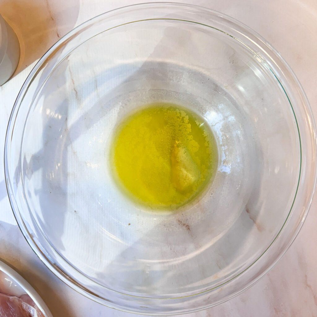 Melted butter and olive oil combined in a glass bowl for the pecan-panko topping.