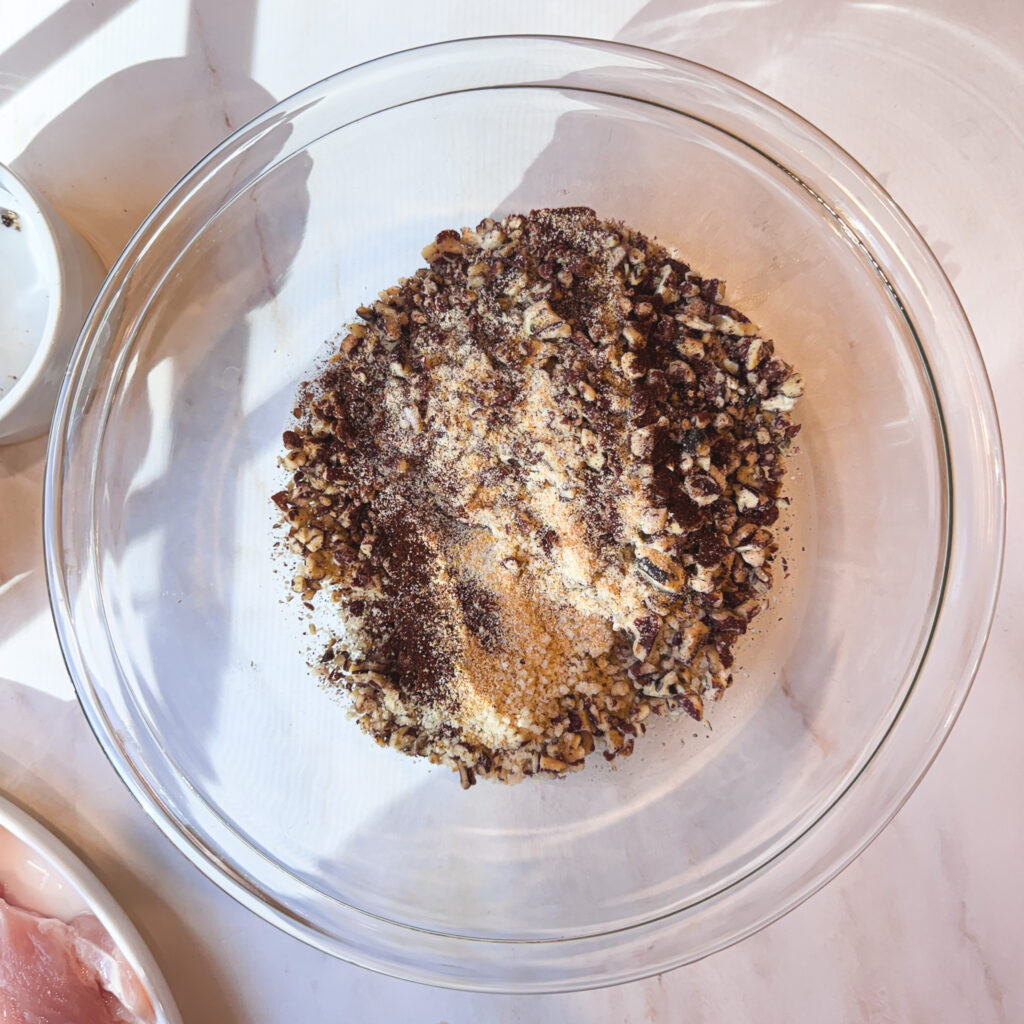 Chopped pecans, panko breadcrumbs, and seasonings ready to be mixed for the chicken crust.